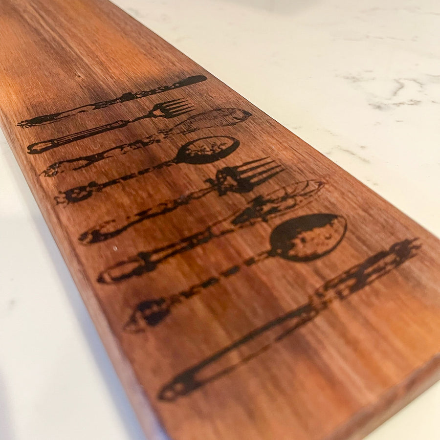 cutting board: wood-burned | cutlery